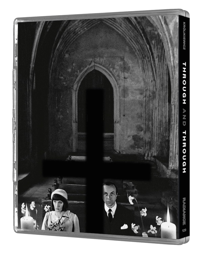 Side view of Through and Through Blu-ray case showing an altar scene with two characters seated, partially obscured by a black cross.