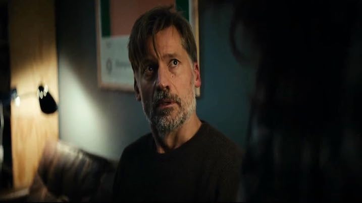 Nikolaj Coster-Waldau returns in Nightwatch Demons are Forever, seen here in a tense indoor exchange.