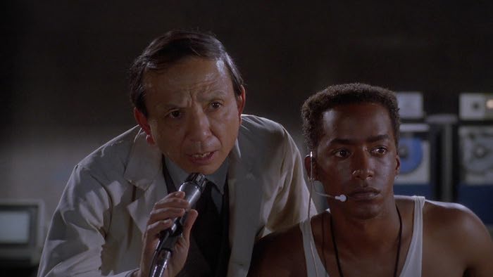 Scene from Shadowzone with scientist and assistant monitoring an experiment.