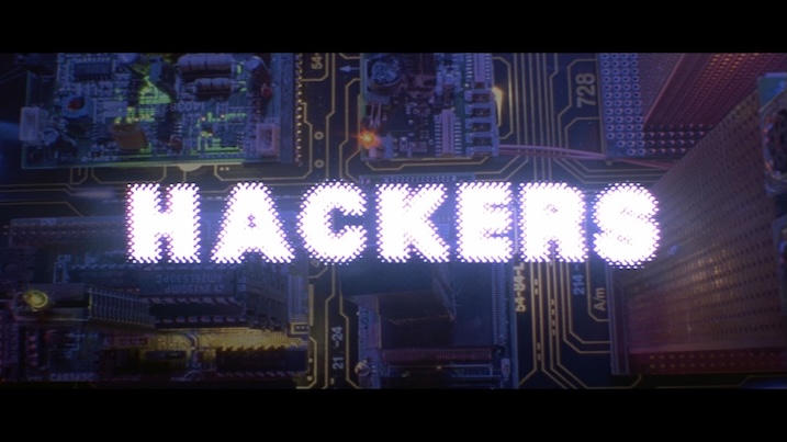 Hackers (1995) film title card – opening credits over a circuit board with “Hackers” glowing in purple lights.
